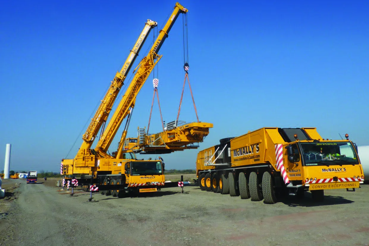 Two McNally’s all-terrain cranes lifting the superstructure onto a Liebherr LG 1750 carrier on a wind farm site